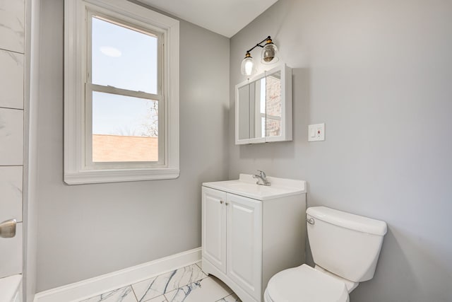 bathroom with toilet, baseboards, marble finish floor, and vanity