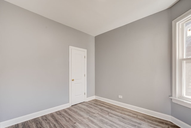 unfurnished room featuring baseboards and wood finished floors