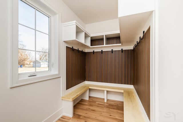 mudroom with baseboards, plenty of natural light, and light wood finished floors