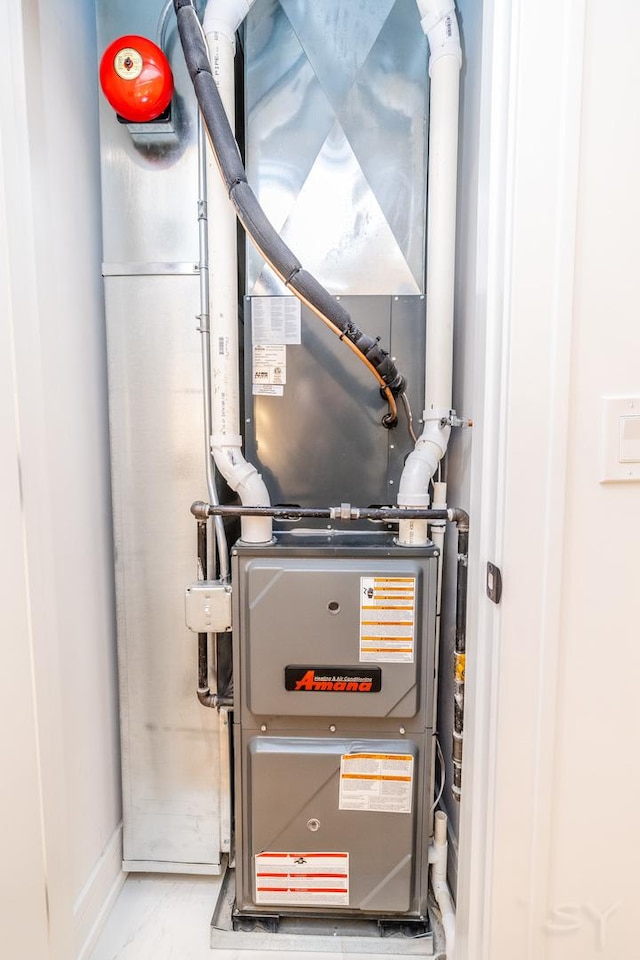 utility room featuring heating unit