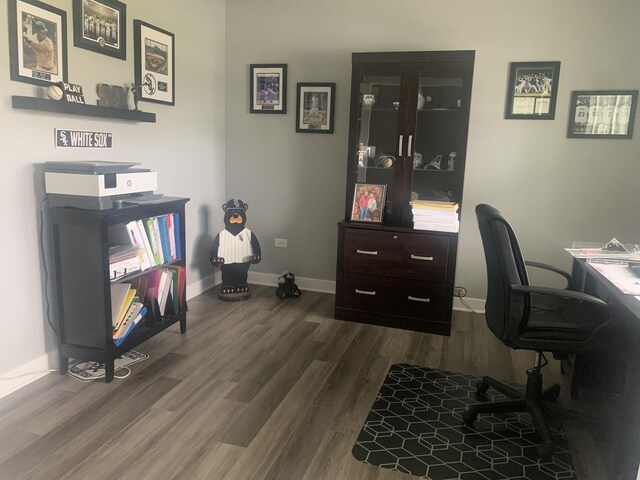 office area with baseboards and dark wood finished floors