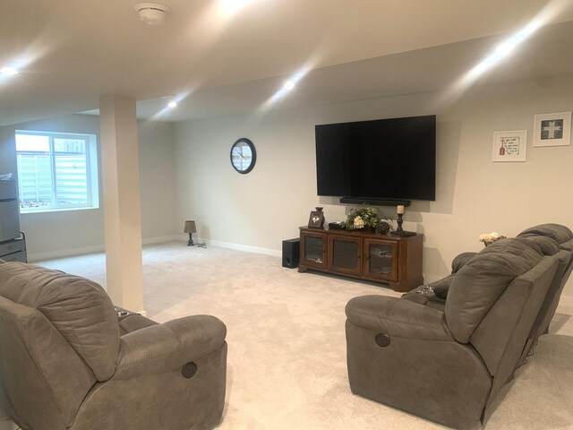 living room with baseboards and light carpet