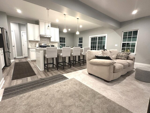 living room with recessed lighting, baseboards, and dark wood finished floors