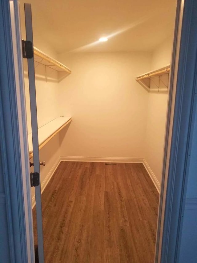 10455 S Forest Ave, Chicago, IL 60628 - walk in closet featuring dark wood-type flooring