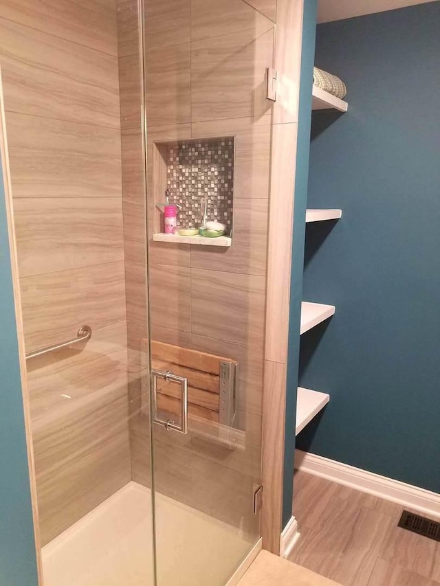 10455 S Forest Ave, Chicago, IL 60628 - bathroom with baseboards, a stall shower, visible vents, and wood finished floors