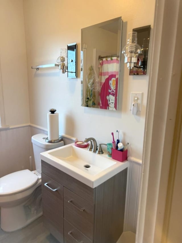 10455 S Forest Ave, Chicago, IL 60628 - bathroom featuring vanity, wainscoting, toilet, and a shower with curtain