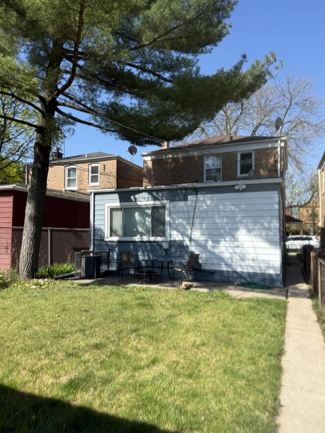 10455 S Forest Ave, Chicago, IL 60628 - view of front of home featuring a patio area, fence, and a front yard