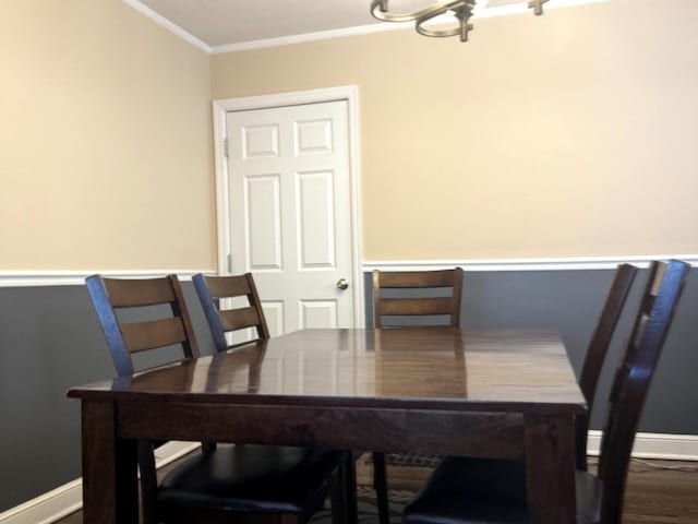 10455 S Forest Ave, Chicago, IL 60628 - dining area with crown molding, baseboards, a notable chandelier, and wood finished floors