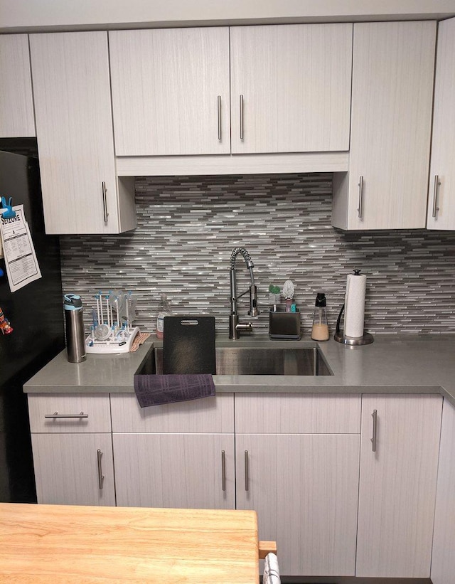 10455 S Forest Ave, Chicago, IL 60628 - kitchen with a sink, tasteful backsplash, and freestanding refrigerator