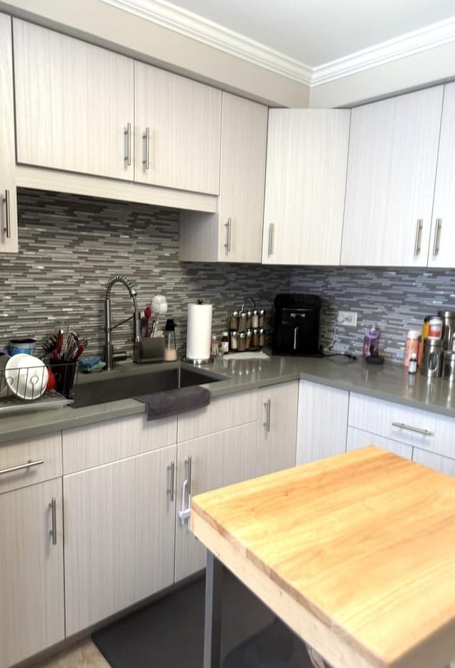 10455 S Forest Ave, Chicago, IL 60628 - kitchen with backsplash, wood counters, ornamental molding, and a sink