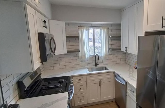 55 W 64th St Unit 202, Westmont, IL 60559 - kitchen featuring backsplash, white cabinets, appliances with stainless steel finishes, and a sink