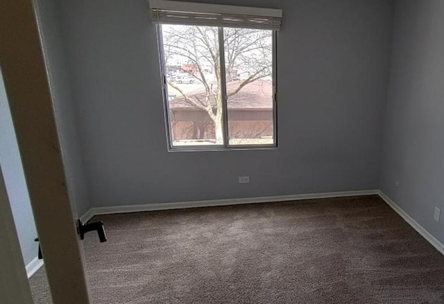 55 W 64th St Unit 202, Westmont, IL 60559 - empty room featuring a healthy amount of sunlight, baseboards, and dark carpet