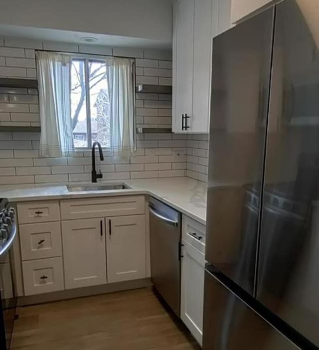 55 W 64th St Unit 202, Westmont, IL 60559 - kitchen with freestanding refrigerator, decorative backsplash, a sink, and dishwasher
