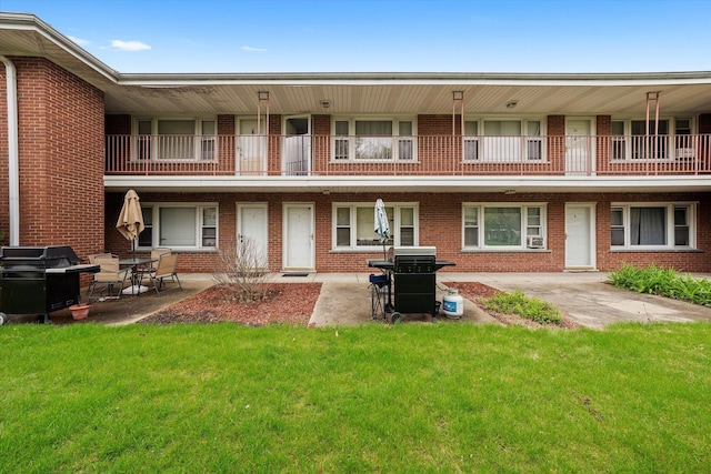 165 Dover Dr Unit 3, Des Plaines, IL 60018 - back of property featuring a yard, a patio, and brick siding