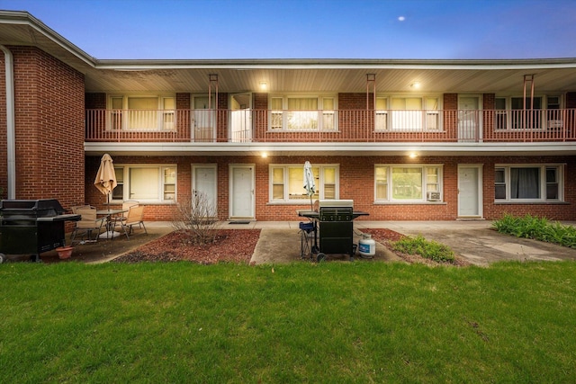 165 Dover Dr Unit 3, Des Plaines, IL 60018 - back of property with a lawn, a patio area, a balcony, and brick siding