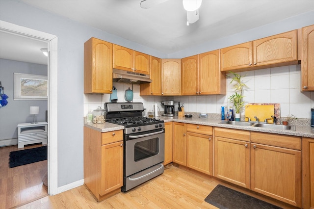 165 Dover Dr Unit 3, Des Plaines, IL 60018 - kitchen with a sink, stainless steel gas range oven, light wood finished floors, backsplash, and under cabinet range hood