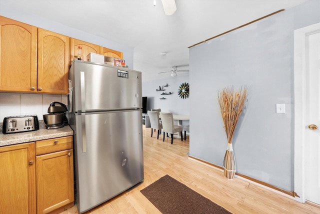 165 Dover Dr Unit 3, Des Plaines, IL 60018 - kitchen featuring freestanding refrigerator, light wood-style floors, ceiling fan, light countertops, and tasteful backsplash