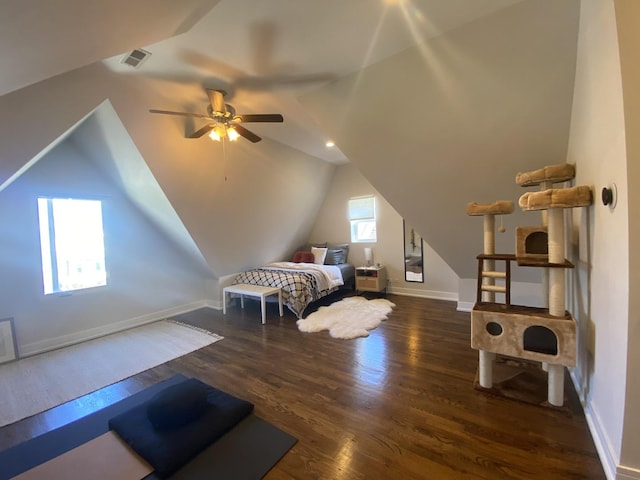bedroom featuring ceiling fan, visible vents, wood finished floors, baseboards, and lofted ceiling