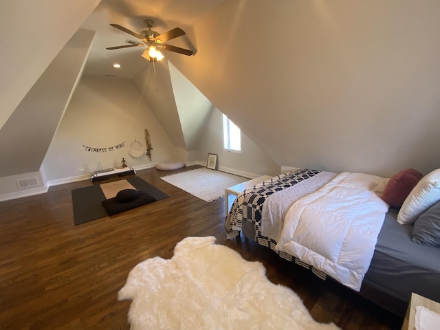 bedroom featuring ceiling fan, visible vents, wood finished floors, baseboards, and lofted ceiling