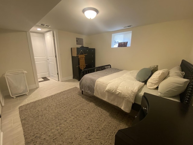 bedroom featuring visible vents, baseboards, and light tile patterned floors