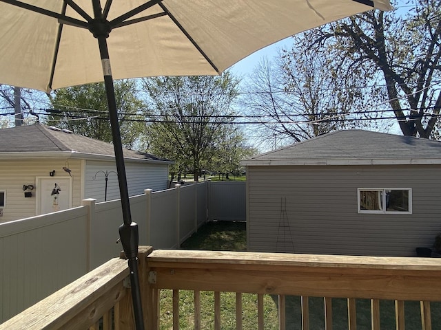 exterior space featuring fence and roof with shingles