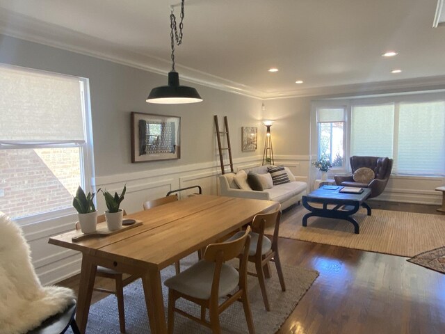dining room featuring wainscoting, dark wood-style floors, ornamental molding, and recessed lighting