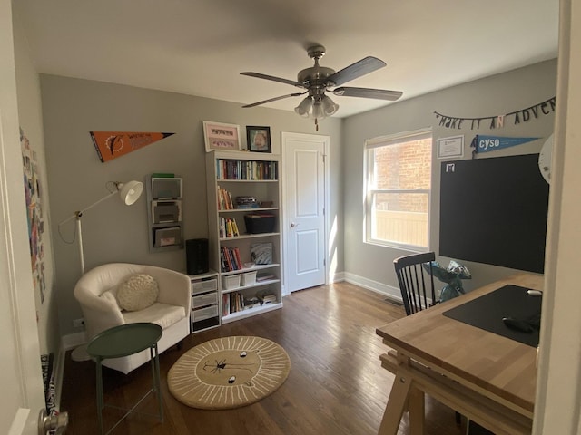 home office with baseboards, ceiling fan, wood finished floors, and visible vents