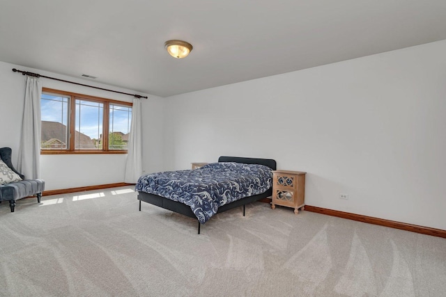 bedroom featuring baseboards, visible vents, and carpet