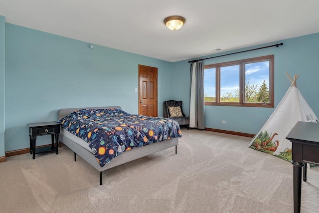 bedroom with carpet floors, baseboards, and visible vents