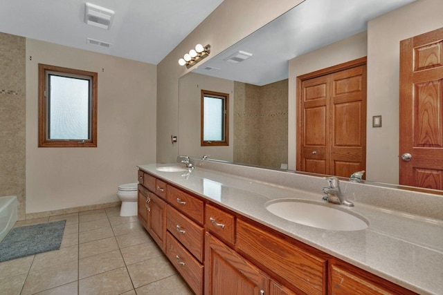 bathroom with toilet, visible vents, a wealth of natural light, and a sink