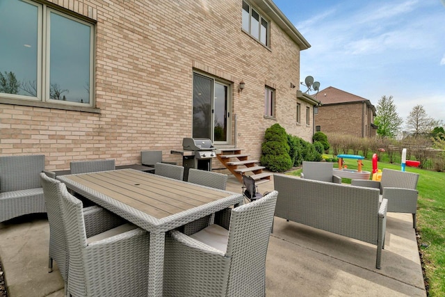 view of patio featuring outdoor dining area, outdoor lounge area, and entry steps
