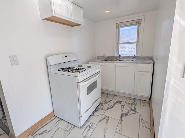 7549 S Perry Ave, Chicago, IL 60620 - kitchen featuring marble finish floor, white gas stove, light countertops, white cabinetry, and a sink