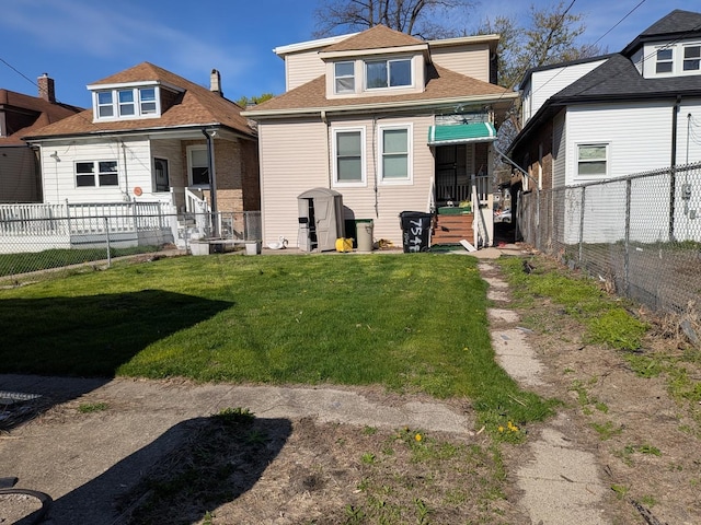 7549 S Perry Ave, Chicago, IL 60620 - rear view of house featuring a lawn, fence private yard, and roof with shingles