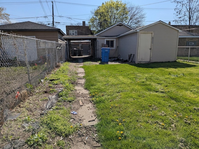 7549 S Perry Ave, Chicago, IL 60620 - view of yard with an outdoor structure, a fenced backyard, and a shed