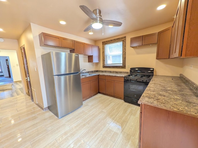 7549 S Perry Ave, Chicago, IL 60620 - kitchen with black range with gas cooktop, a ceiling fan, brown cabinets, freestanding refrigerator, and recessed lighting