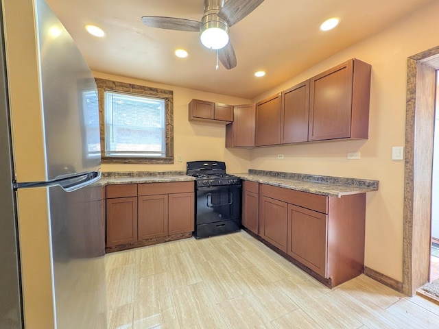 7549 S Perry Ave, Chicago, IL 60620 - kitchen featuring freestanding refrigerator, a ceiling fan, brown cabinetry, and black gas stove