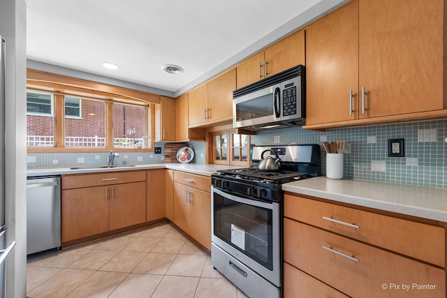 622 Katherine St, Saint Charles, IL 60174 - kitchen with stainless steel appliances, light countertops, backsplash, and light tile patterned floors