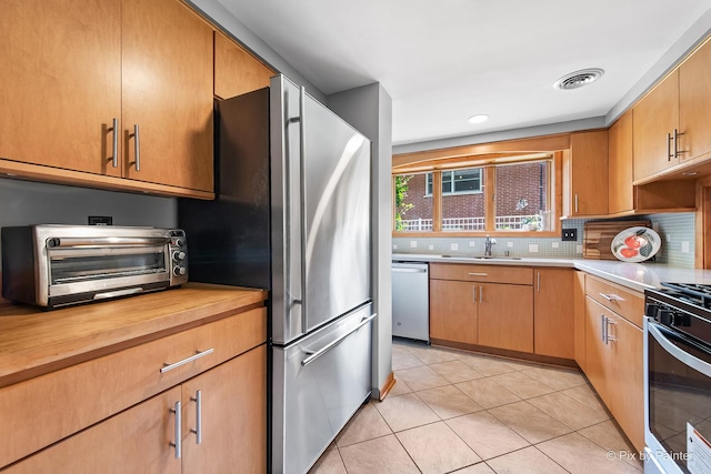 622 Katherine St, Saint Charles, IL 60174 - kitchen featuring appliances with stainless steel finishes, light tile patterned floors, backsplash, and wooden counters