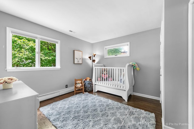 622 Katherine St, Saint Charles, IL 60174 - bedroom featuring a baseboard radiator, multiple windows, a nursery area, and wood finished floors