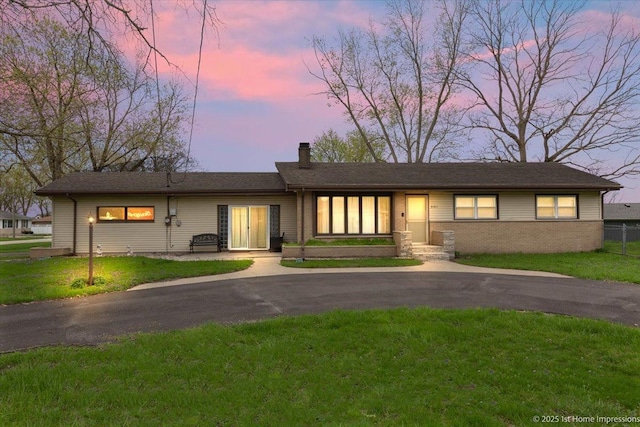 view of front of house with a chimney and a front yard