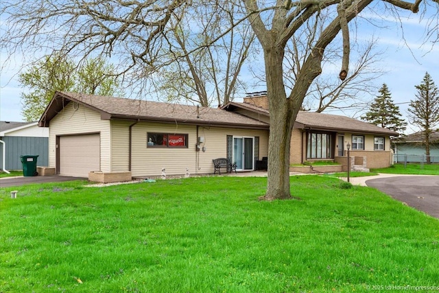 ranch-style house featuring driveway, a garage, fence, a front lawn, and a shingled roof