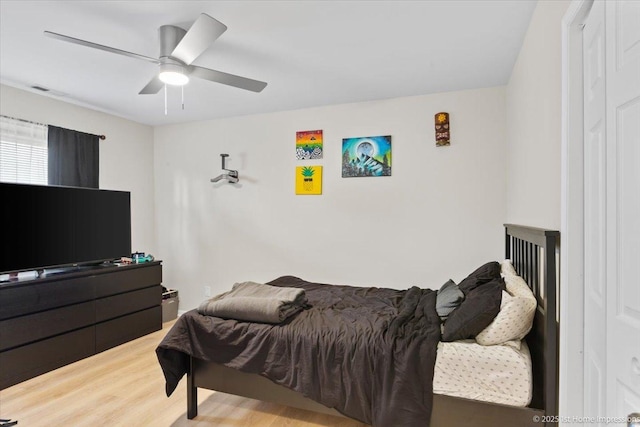 bedroom with a ceiling fan and wood finished floors