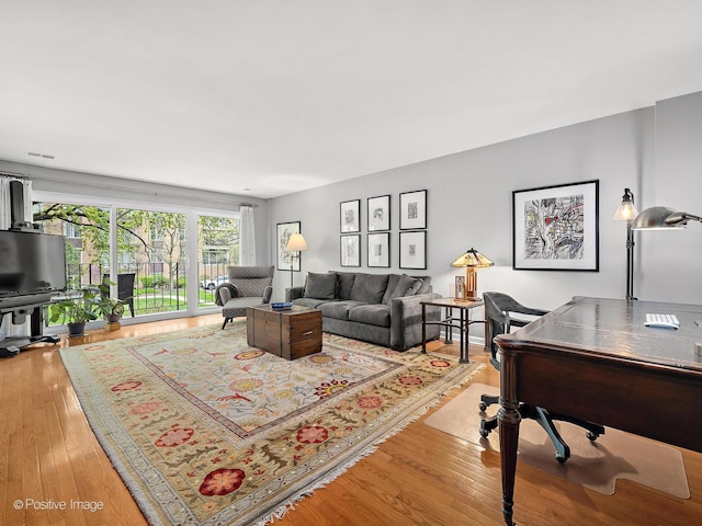 living room featuring light wood finished floors and visible vents