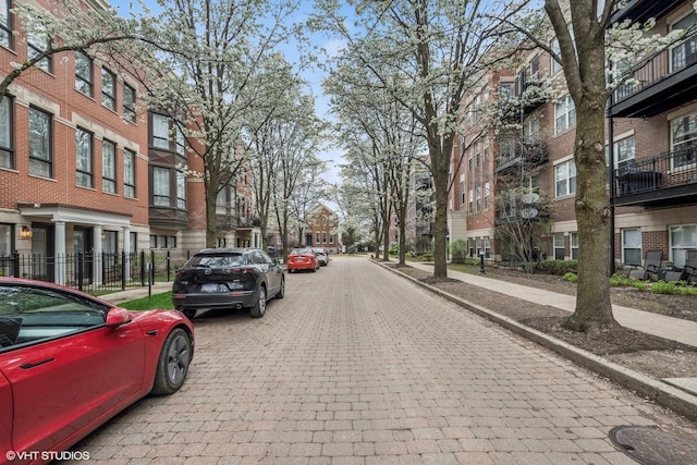 view of street with curbs, sidewalks, and a residential view