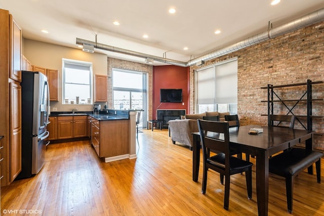 949 N Willard Ct Unit 302, Chicago, IL 60642 - kitchen with stainless steel fridge, dark countertops, a sink, light wood-type flooring, and recessed lighting