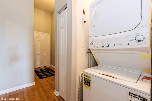 949 N Willard Ct Unit 302, Chicago, IL 60642 - washroom with stacked washer / dryer, wood finished floors, and baseboards