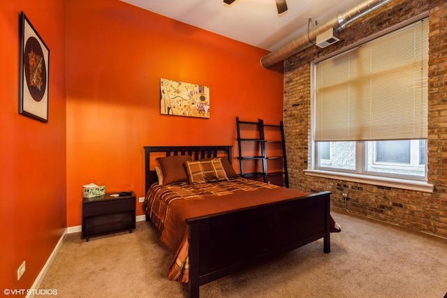 949 N Willard Ct Unit 302, Chicago, IL 60642 - bedroom with carpet flooring, brick wall, a ceiling fan, and baseboards