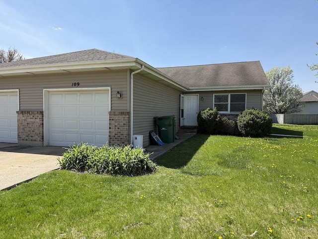 single story home featuring a front yard, brick siding, fence, concrete driveway, and an attached garage