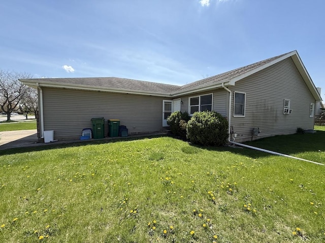 rear view of property with a yard