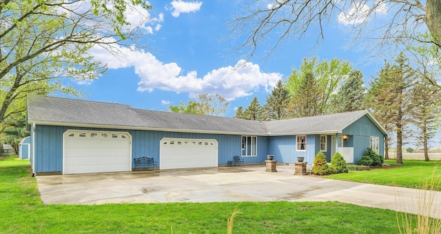 ranch-style house featuring an attached garage, a front lawn, and driveway